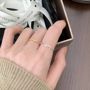 Minimalist silver and gold wave rings set presented in a stylish gift box with ribbon