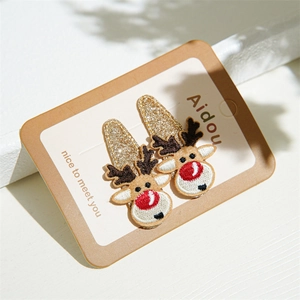Detail of Christmas reindeer hair clips set with gold glitter and embroidery