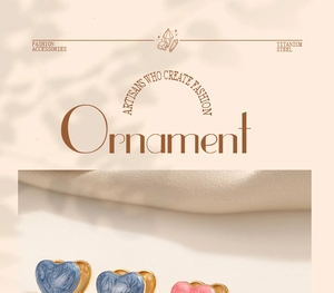 Detailed macro shot of heart-shaped titanium steel earrings with marble texture