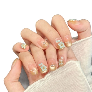 Pink and gold gradient press-on nails with 3D celadon flowers and tiny pearls
