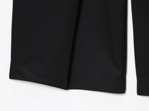 Detailed macro view of black twill suit fabric showing refined material texture and weave