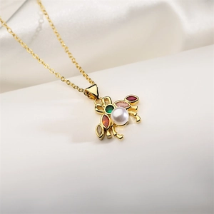 Close-up of golden crab pendant featuring white pearl and colorful gemstones on a chain