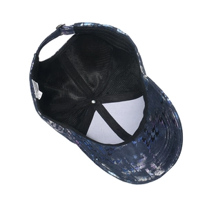 Detail view of tie-dye baseball cap interior with sweatband and adjustable metal buckle