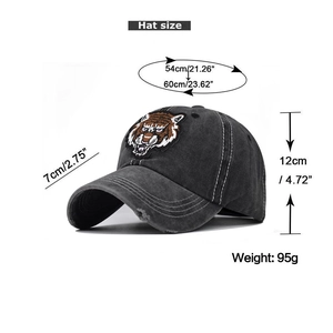 Close-up of tiger head embroidery and distressed details on a washed cotton baseball cap