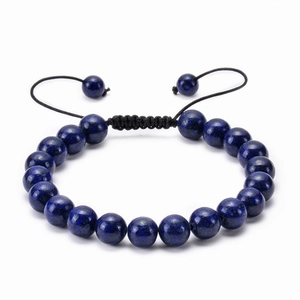 Deep blue natural stone beaded bracelet with adjustable black woven cord on white background