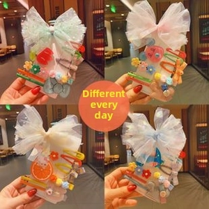 Detailed view of colorful children hair accessory sets featuring bows and cartoon clips