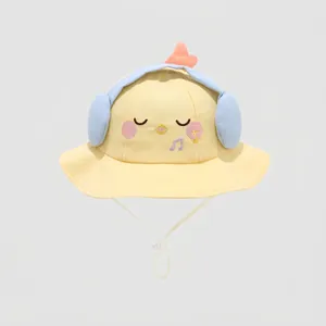 Close-up of yellow baby sun hat with cute chick embroidery and 3D headphone details