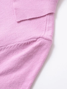 Close-up of fine knit texture and high-quality stitching on a pink polo collar sweater