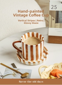 Close-up of hand-painted ceramic coffee cup with retro stripes and glossy finish