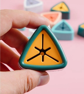 Close-up of hand holding a triangular towel holder with a soft silicone star-shaped opening