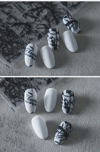 Macro detail of monochrome ink marble nail stickers with elegant abstract line art