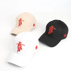 Three embroidered baseball caps in beige, black, and white with red star and character