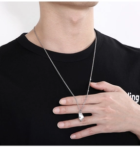 Detailed view of silver irregular geometric crescent moon necklace worn by a model