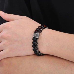 Close-up of double-layer beaded bracelet featuring tiger eye stones and black metal chain