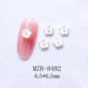 Detail of 6.5mm 3D white flower nail charms with pearl center and silver metal edges