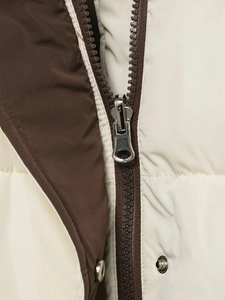 Detail of brown and off-white quilted jacket with nylon zipper and silver metal snap buttons
