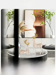Close-up of elegant clear resin elk statues with gold foil flakes and golden antlers