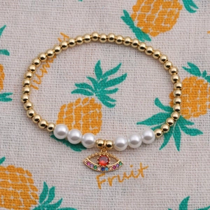 Bohemian evil eye bead bracelet with gold metal beads, white pearls and colorful zircon