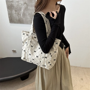 Beige corduroy quilted tote bag with black bows for women stylish everyday use