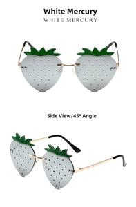 Macro view of silver strawberry shaped frameless sunglasses with green leaf accents