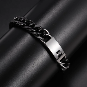 Detailed close-up of matte black link bracelet with polished silver clasp for men