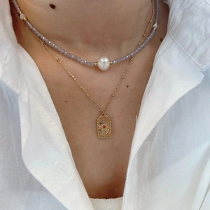 Layered amethyst bead necklace with white pearl and gold engraved stone pendant