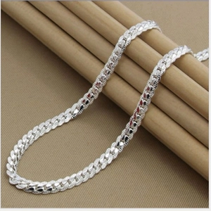 Minimalist 5mm silver-plated curb chain necklace draped over elegant wooden supports