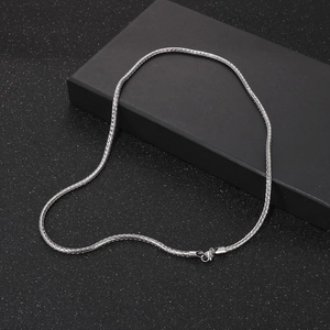 Detail of silver woven chain necklace featuring a secure lobster claw clasp closure