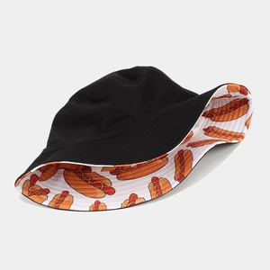 Close-up of reversible bucket hat showing black fabric and cartoon hot dog pattern