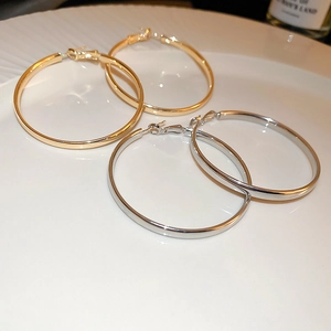 Fashionable large geometric circle hoop earrings in polished gold and silver metal finishes