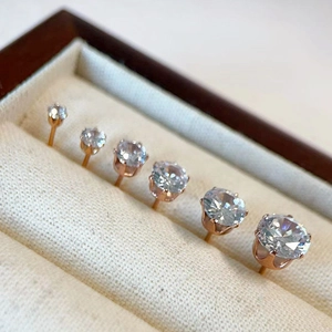Macro view of six sizes of rose gold cubic zirconia stud earrings in a wooden box