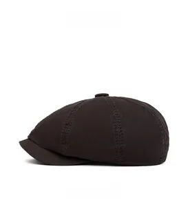 Side view of a vintage cotton newsboy cap in dark brown with stitching details