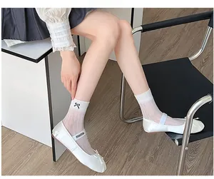 Detail of white satin ballet flats with bow and striped socks in a trendy aesthetic