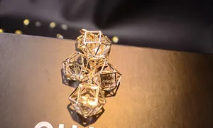 Detailed macro view of geometric gold rhombus frames with clear sparkling crystal pendants