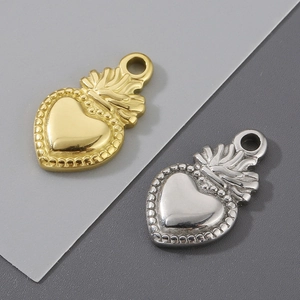 Macro view of gold and silver heart pendants with flame and beaded crown details