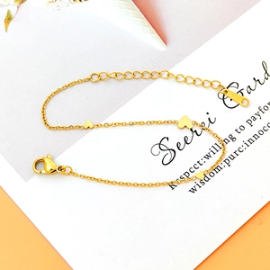 Elegant gold titanium bracelet with three polished heart charms and adjustable lobster clasp