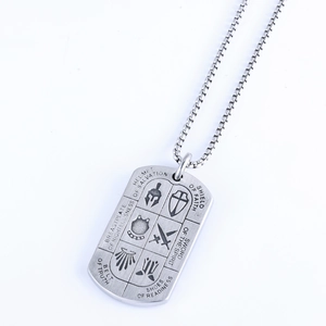 Detail of silver dog tag necklace featuring engraved Armor of God religious text