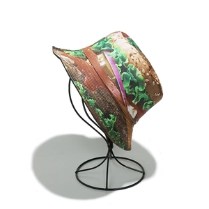 Detailed close-up of a bucket hat with realistic hamburger print on white background