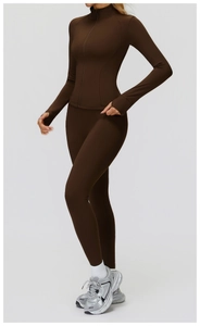 Detailed close-up of dark brown athletic jacket with thumbhole cuffs and matte fabric texture