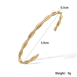 Detail view of 18K gold plated C-shaped twisted cuff bracelet with 5.9cm inner diameter