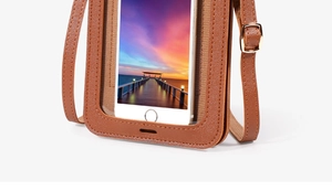 Detail of brown leather phone bag showing precise stitching and adjustable buckle hardware