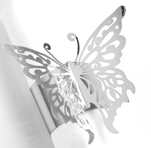 Detailed macro view of a silver hollow-out butterfly metal napkin ring for wedding decor