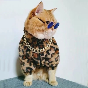 Leopard print pet winter coat with gold chain and blue sunglasses on a cat model