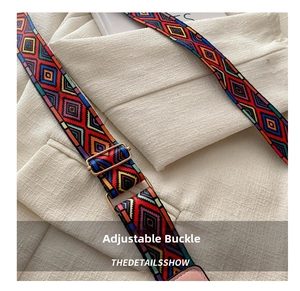 Close-up of ethnic woven strap with geometric patterns and adjustable golden metal buckle