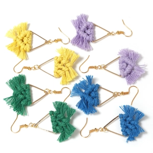 Detailed close-up of handmade bohemian fringe earrings with colorful cotton tassels