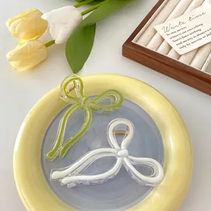 Elegant bow hair claws in jelly green and white acrylic for minimalist hair styling