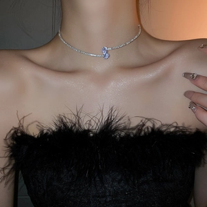 Detail of silver double-layered zircon teardrop necklace on model collarbone