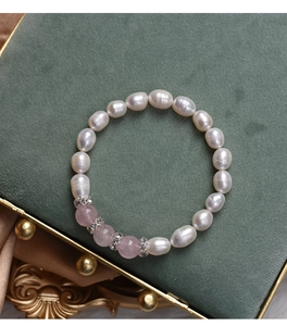 Detailed macro view of natural freshwater pearls and pink gemstone beaded bracelet