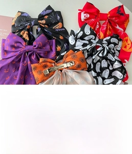 Detailed set of five Halloween bow hair clips with pumpkin and ghost prints on fabric