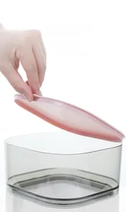 Close-up of a square airtight food container with translucent body and pink lid